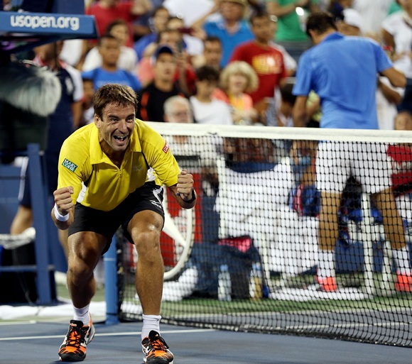 Tommy Robredo of Spain reacts after defeating Roger Federer