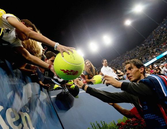 Rafael Nadal of Spain signs autographs for fans
