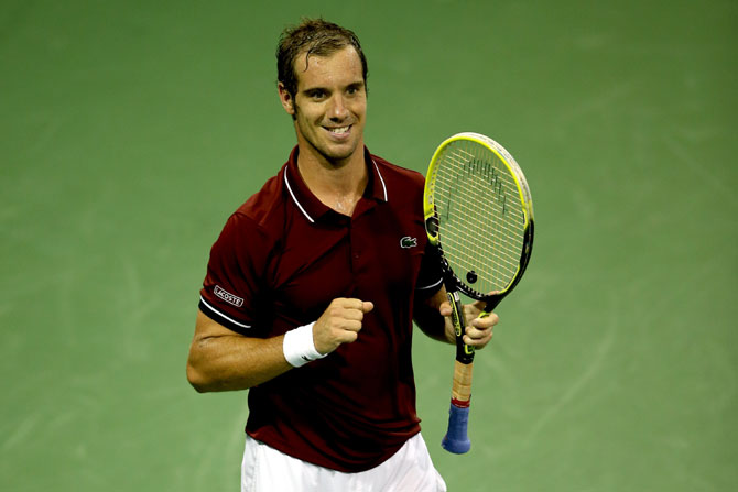 Richard Gasquet of France celebrates match point against Milos Roanic of Canada during their fourth round match