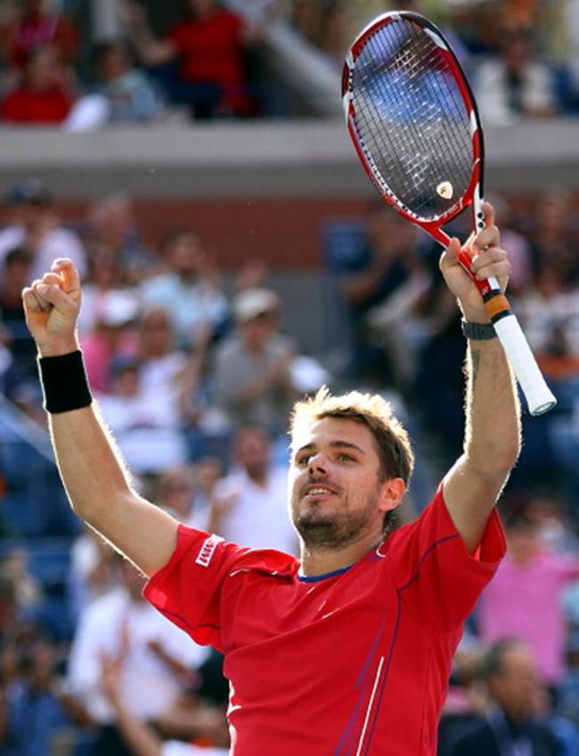 Stanislas Wawrinka of Switzerland celebrates match-point during his men's singles quarter-final against Andy Murray of Great Britain