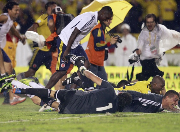 Colombia's team members celebrate after defeating Ecuador