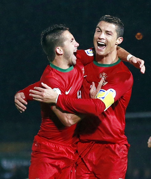 Portugal's Cristiano Ronaldo celebrates with teammate Joao Moutinho