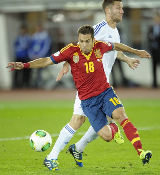 Spain's Jordi Alba (front) dribbles past Finland's Joona Toivio to score