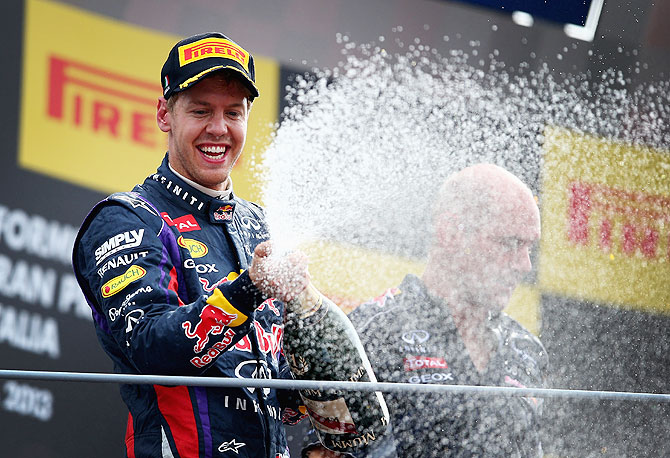 Sebastian Vettel of Germany and Infiniti Red Bull Racing celebrates on the podium after winning the Italian Formula One Grand Prix on Sunday