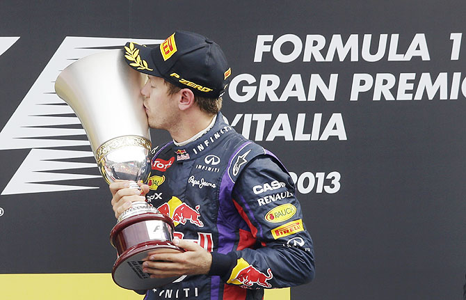 Red Bull Formula One driver Sebastian Vettel of Germany kisses his trophy on the podium after winning the Italian F1 Grand Prix on Sunday