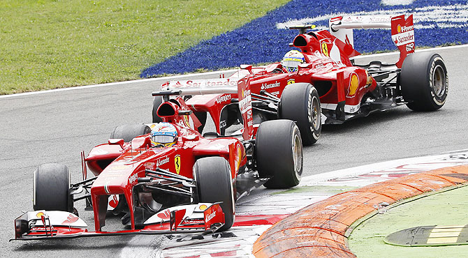 Ferrari Formula One driver Fernando Alonso of Spain drives ahead of teammate Felipe Massa of Brazil during the Italian F1 Grand Prix on Sunday