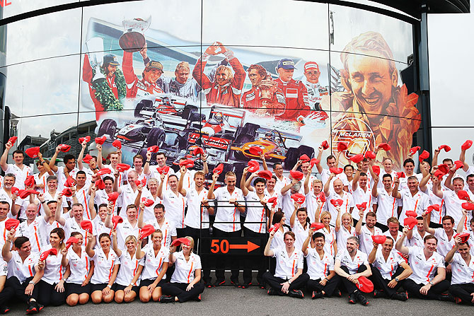 Jenson Button, Martin Whitmarsh and Sergio Perez and McLaren teammates pose for a team photograph as they celebrate their 50th year in Formula One during the Italian Formula One Grand Prix on Sunday