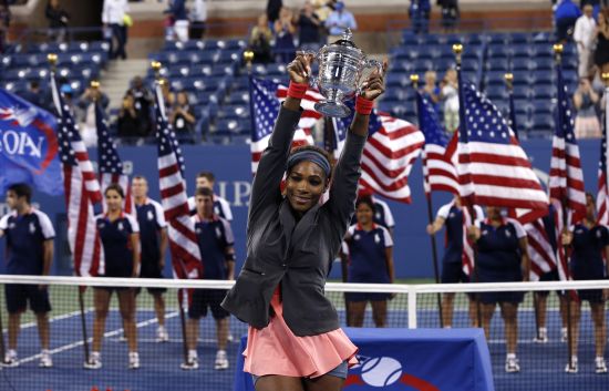 Serena Williams of the U.S. raises her trophy after defeating Victoria Azarenka of Belarus in their women's singles final match at the U.S. Open tennis championships