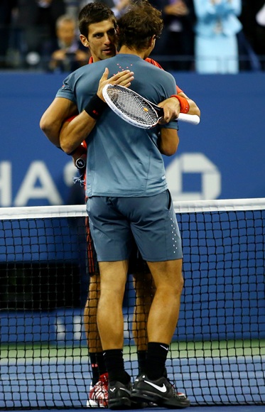 Rafael Nadal of Spain hugs Novak Djokovic of Serbia