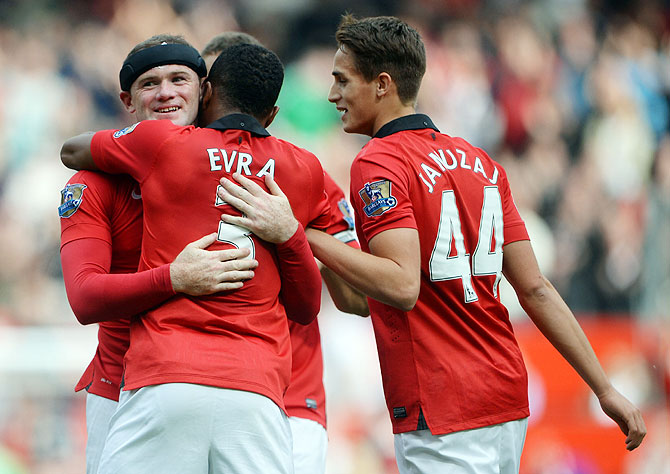 Wayne Rooney of Manchester United is congratulated by Patrice Evra (3) and Adnan Januzaj (44) after scoring against Crystal Palace at Old Trafford in Manchester on Saturday