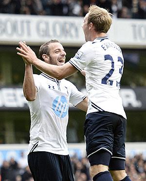 Tottenham Hotspur's Roberto Soldado (left) and Christian Eriksen celebrate teammate Gylfi Sigurdsson's goal during their English Premier League match against Norwich City at White Hart Lane in London on Saturday