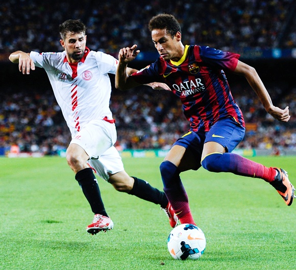 Neymar of FC Barcelona duels for the ball with Jorge Andujar Moreno 'Coke' of Sevilla FC