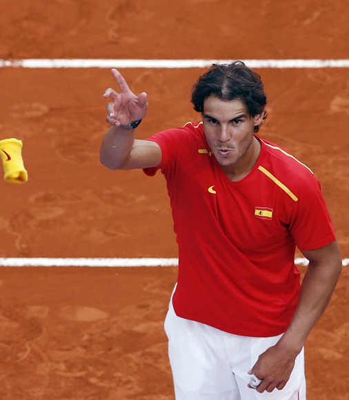 Spain's Rafael Nadal throws his wristband to the public after winning against Ukraine