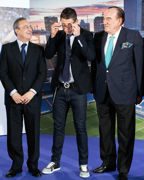 Cristiano Ronaldo (second left) puts on his glasses before posing   alongside Real Madrid president Florentino Perez (left) and Real   Madrid board of management member Fernando Fernandez Tapias (right)