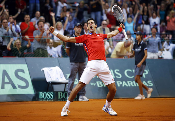 Serbia's Novak Djokovic celebrates his victory over Canada's Milos Raonic