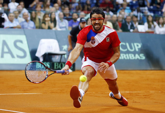 Serbia's Janko Tipsarevic returns the ball to Canada's Vasek Pospisil during their Davis Cup semi-final