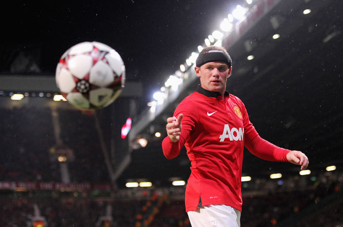 Wayne Rooney of Manchester United retrieves the ball