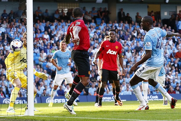 Manchester City's Yaya Toure (rightR) shoots to score