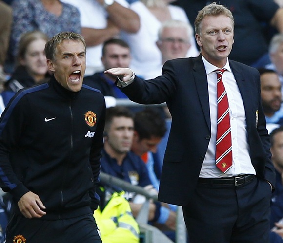 Manchester United's manager David Moyes (right) and assistant Phil Neville