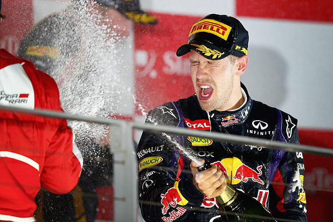 Sebastian Vettel of Germany and Infiniti Red Bull racing celebrates following his victory during the Singapore Formula One Grand Prix at Marina Bay Street Circuit in Singapore on Sunday
