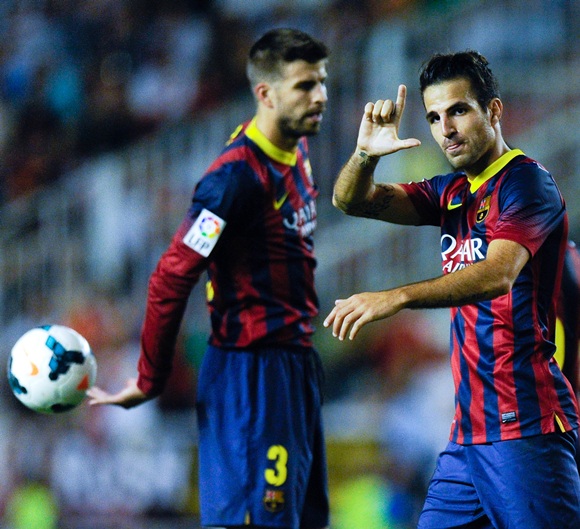 Cesc Fabregas (right) of FC Barcelona celebrates after scoring his team's fourth goal
