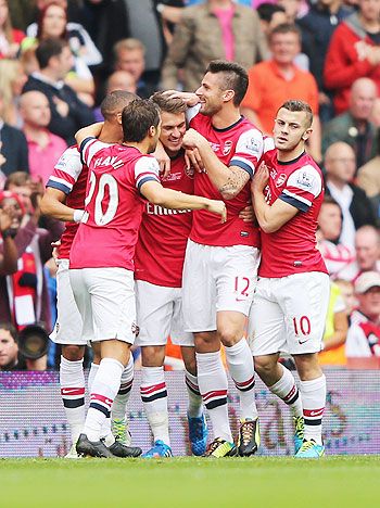 Arsenal's Aaron Ramsey (centre) celebrates with teammates after scoring against Stoke City at Emirates Stadium in London on Sunday