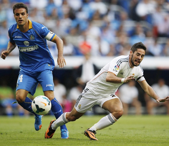 Real Madrid's Isco is tackled by Getafe's Pedro Leon
