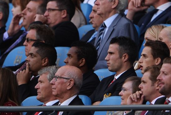 Robin van Persie of Manchester United looks on from the stands during the Barclays Premier League match between Manchester City and Manchester United at the Etihad Stadium