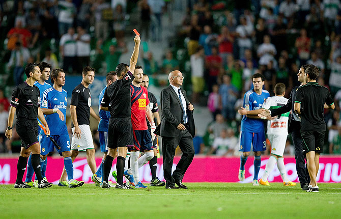 Referee Cesar Muniz Fernandez shows the red card to Carlos Sanchez of Elche FC after their La Liga match at Estadio Manuel Martinez Valero in Elche on Wednesday
