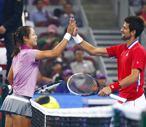 Serbia's Novak Djokovic (right) celebrates with China's Li Na after an exhibition charity match