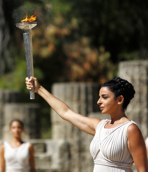 Greek actress Ino Menegaki, playing the role of High Priestess, carries the Olympic Flame during a dress rehearsal for the torch lighting ceremony of the Sochi 2014 Winter Olympic Games