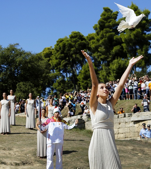 A Greek girl, wearing an ancient robe, releases a white dove during a dress rehearsal for the torch lighting ceremony of the Sochi 2014 Winter Olympic Games