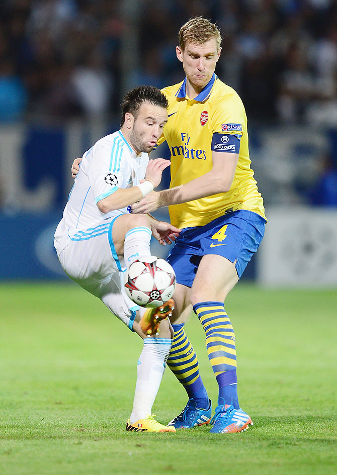 Per Mertesacker of Arsenal battles with Mathieu Valbuena of Olympique Marseille during their UEFA Champions League group F match on September 18