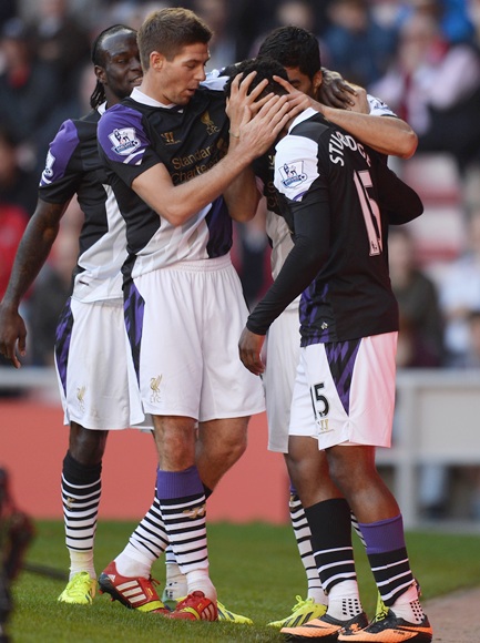 Steven Gerrard of Liverpool celebrates with Luis Suarez and Daniel Sturridge