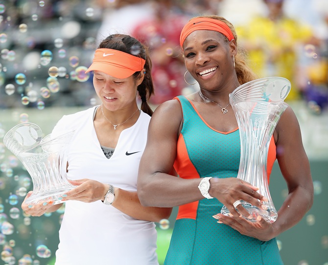 Serena Williams of the United States holds the Butch Buchholz trophy after her straight sets victory over Li Na of China