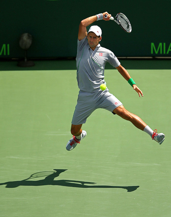 Novak Djokovic of Serbia returns a shot to Rafael Nadal of Spain