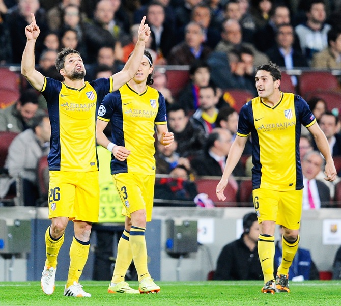 Diego,left, of Club Atletico de Madrid celebrates scoring the opening goal with Filipe Luis and Koke