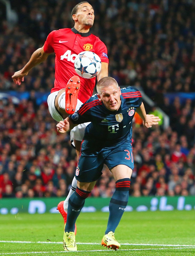 Rio Ferdinand of Manchester United and Bastian Schweinsteiger of Bayern Muenchen battle for the ball