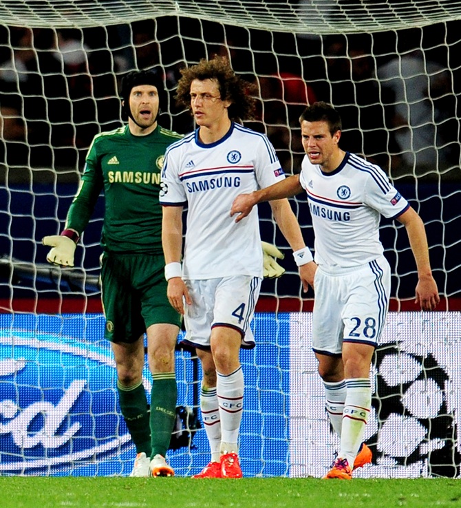 Goalkeeper Petr Cech,left, looks on in disbelief after David Luiz,centre, of Chelsea scores an own goal