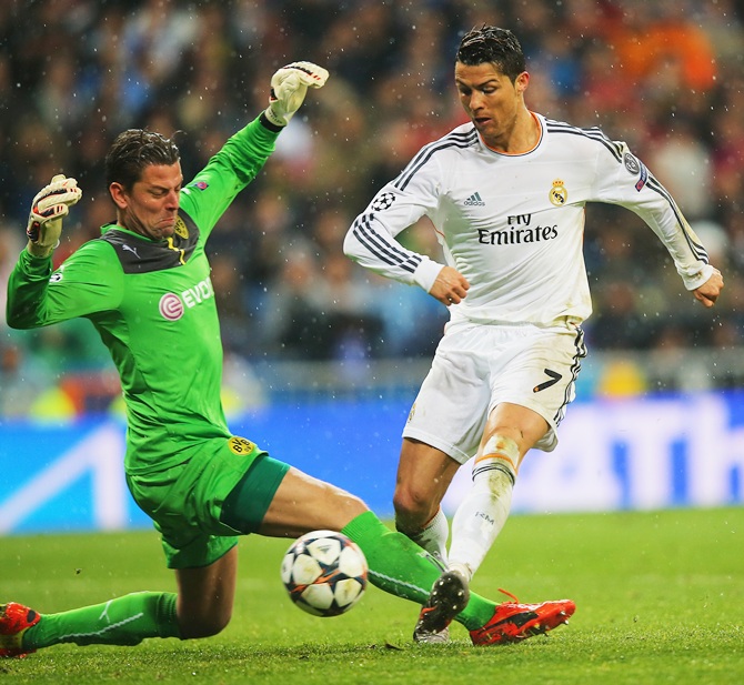 Cristiano Ronaldo of Real Madrid scores past Roman Weidenfeller of Borussia Dortmund