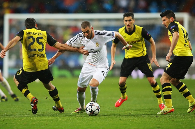 Karim Benzema of Real Madrid takes on Sokratis Papastathopoulos of Borussia Dortmund