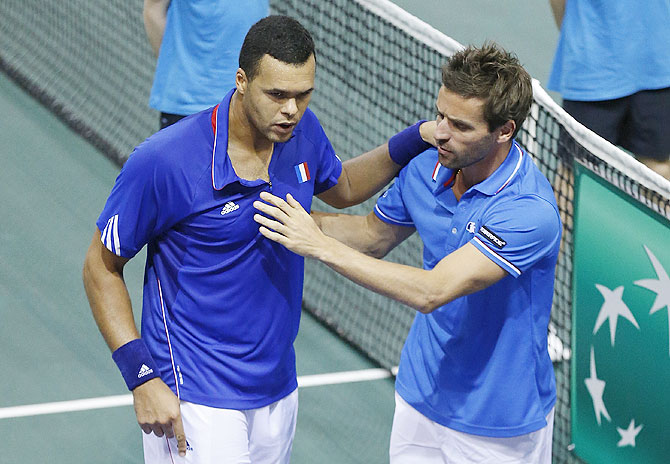 France's team captain Arnaud Clement (right) congratulates Jo-Wilfried Tsonga after his victory against Germany's Tobias Kamke during their Davis Cup quarter-final single tennis match in Nancy, on Sunday
