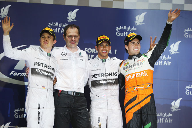 Race winner Lewis Hamilton (2nd from right) of Great Britain and Mercedes GP, second placed Nico Rosberg (left) of Germany and Mercedes GP and third placed Sergio Perez (right) of Mexico and Force India celebrate with Mercedes GP Engineering Director Aldo Costa (2nd from left) following the Bahrain Formula One Grand Prix at the Bahrain International Circuit in Sakhir, Bahrain on Sunday