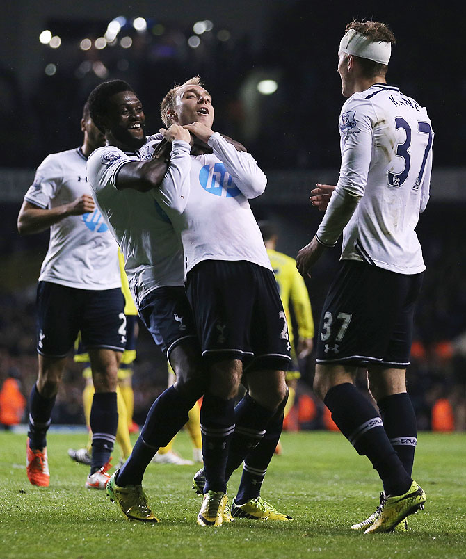 Christian Eriksen of Tottenham Hotspur celebrates with teammates after scoring his team's third goal against Sunderland during their English Premier League match at White Hart Lane in London on Monday