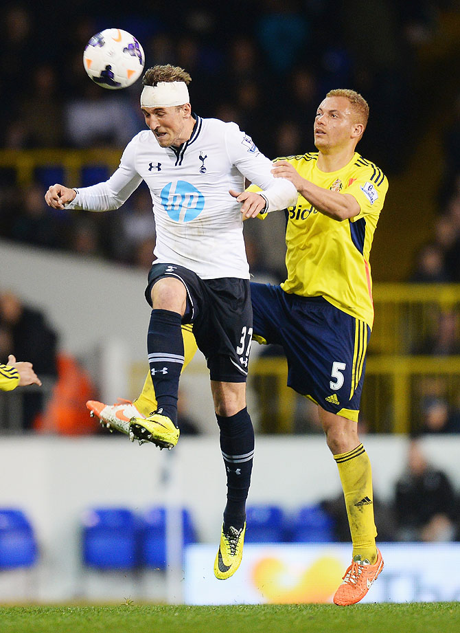 Harry Kane of Tottenham Hotspur wins a header against Wes Brown of Sunderland on Monday