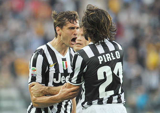 Fernando Lorente (Left) of Juventus celebrates with teammate Andrea Pirlo after scoring his second goal against Livorno at Juventus Arena in Turin on Monday