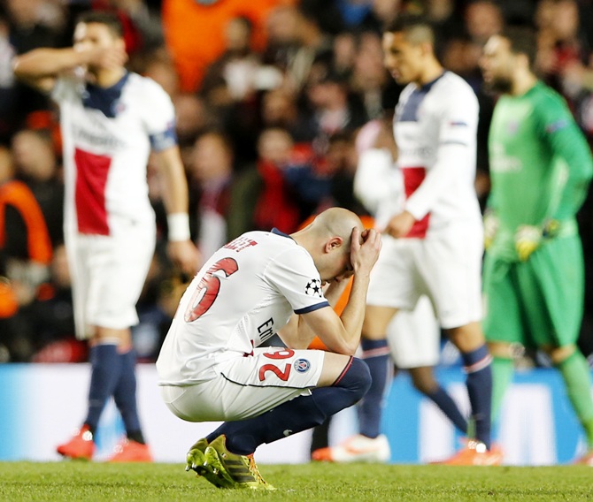 Paris St Germain's Christophe Jallet and teammates react after being defeated by Chelsea