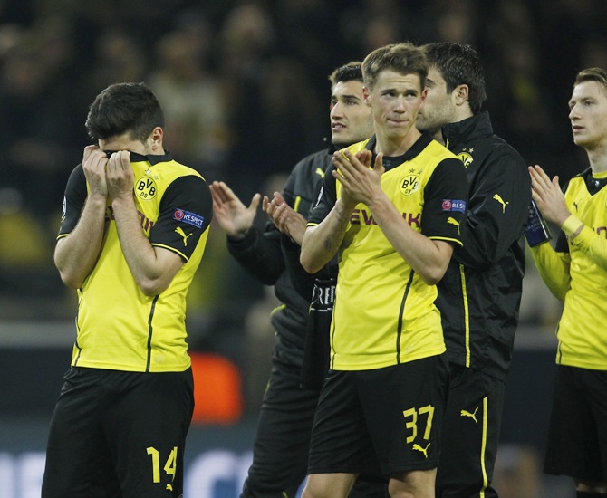 Borussia Dortmund's players react after their Champions League quarter-final second leg soccer match against Real Madrid in Dortmund