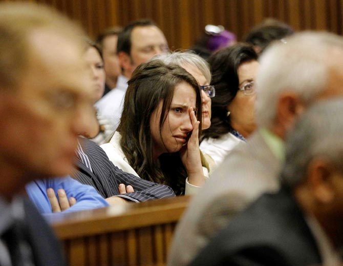 Aimee Pistorius, sister of South African Olympic and Paralympic sprinter Oscar Pistorius cries as he gives evidence during his trial at the high court in Pretoria