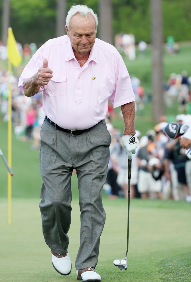 Arnold Palmer walks off a green during the 2014 Par 3 Contest prior to the   start of the 2014 Masters Tournament at Augusta National Golf Club